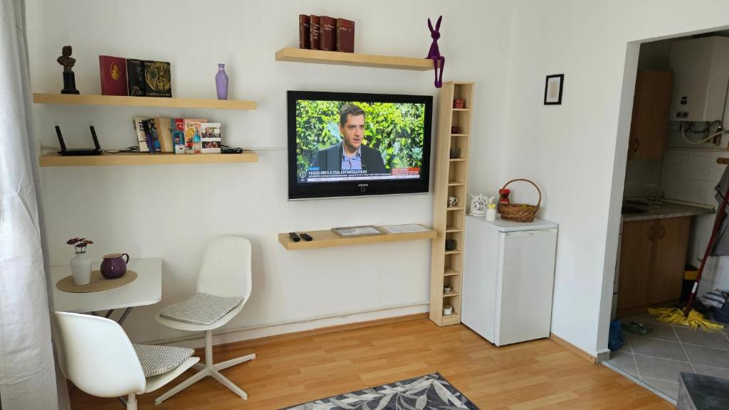 a living room with a television on a wall at Apartmán Centrum in Komárno