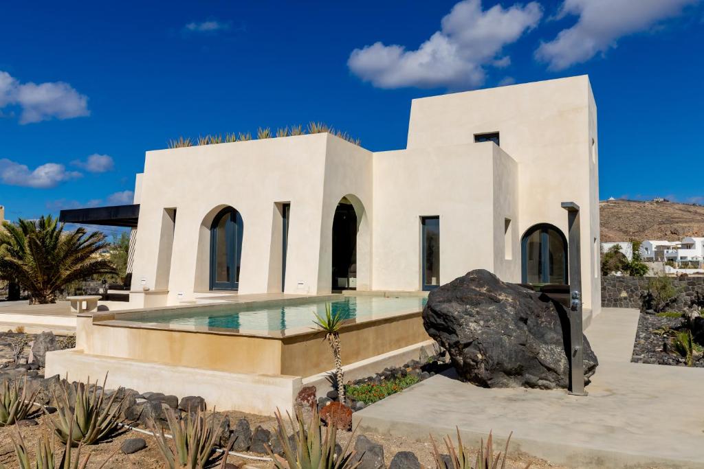 a house in the desert with a swimming pool at Exomitis1 Cellar & Sea Escape in Agios Georgios Thalassiti