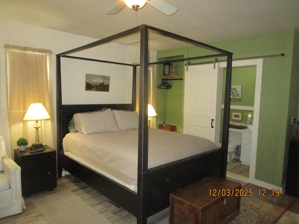 a bedroom with a canopy bed in a room at Bunkhouse on Bomoseen in Castleton