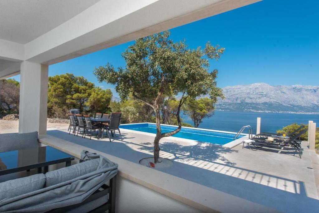 a view of the water from the balcony of a house at Villa Azure Bay in Povlja