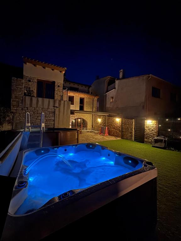 a blue hot tub in a yard at night at Cal Bertran in Segura