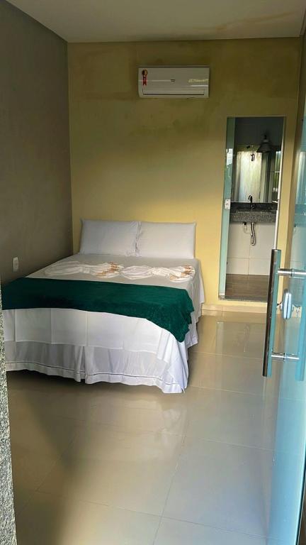a bedroom with a bed and a mirror in a room at Pousada da Samira in Andaraí