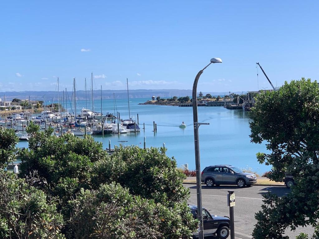 a car parked in a parking lot next to a marina at The Bay Riveria in Napier