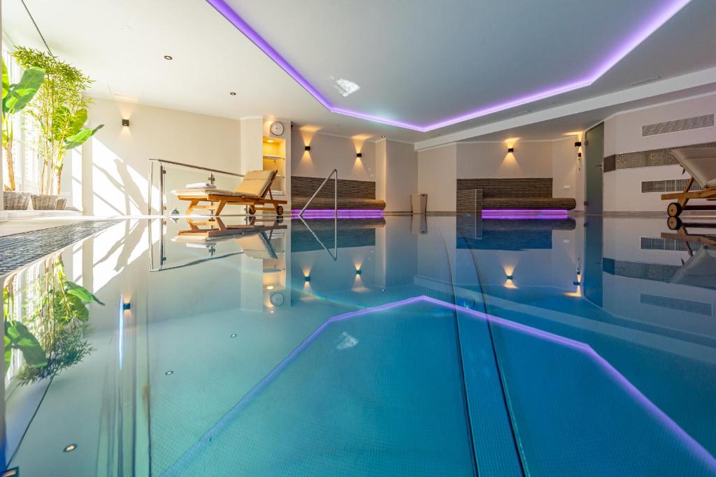 a swimming pool with blue water in a house at Kampenkliff ehemals Walter´s Hof in Kampen