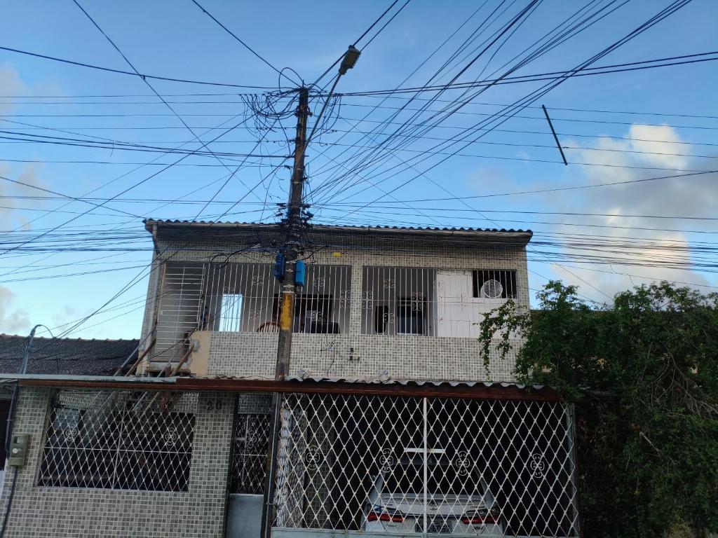 a house with a fence in front of it at Flat, primeiro andar, perto do Chevrolet Hall e Centro de Convenções e in Recife