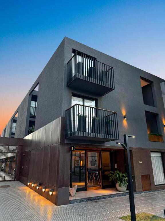 a building with two balconies on top of it at Bertolino Hotel in Villa Mercedes