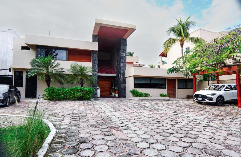 a house with a driveway in front of it at Villa Maraf - Adults Only Boutique Hotel in Cancún