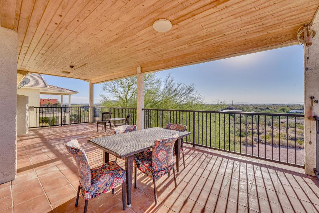 a patio with a table and chairs on a deck at Private Hot Tub & Epic Views in Superstition Mtns! in Apache Junction