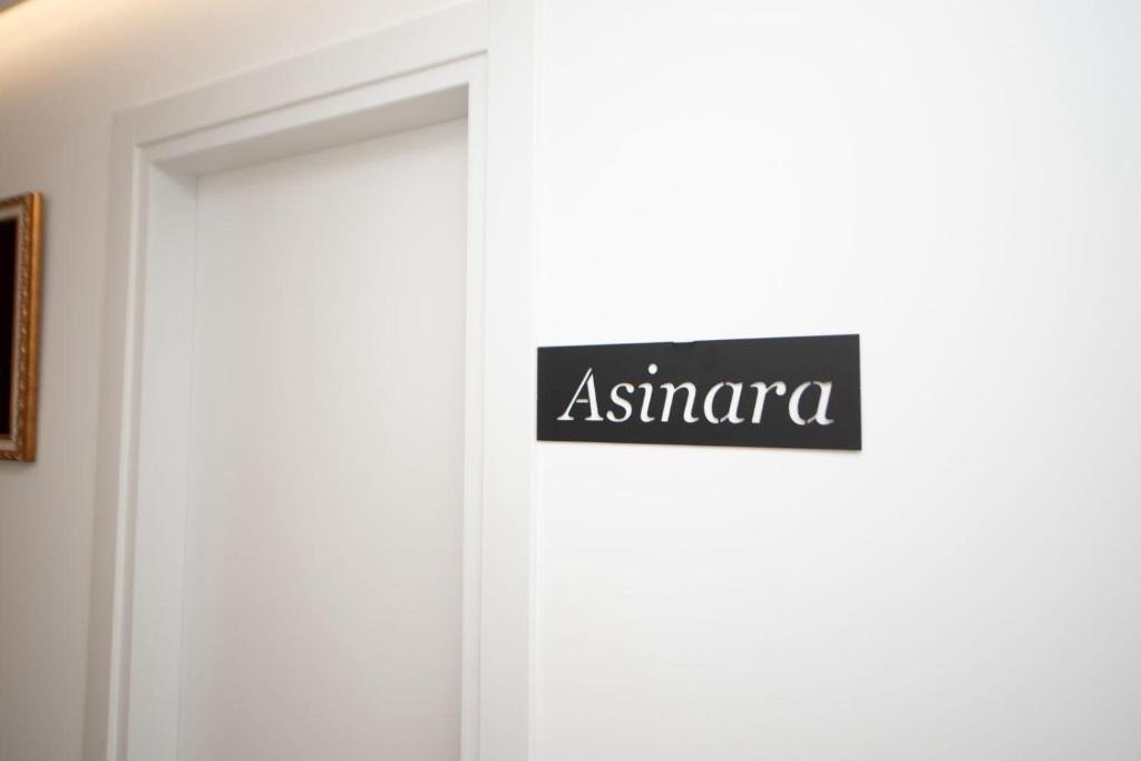 a sign on a door that says asiana at Asinara Guatanamo Belmarsh in Durrës