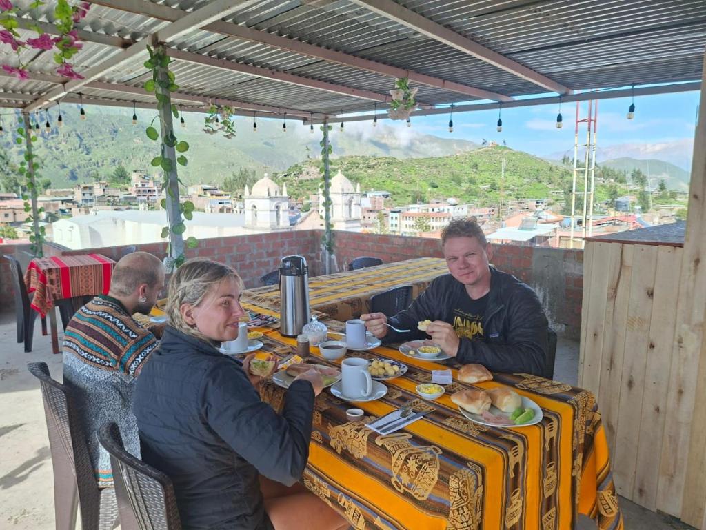 a group of people sitting at a table eating food at HOTEL CHOQOLAqA RESTAURANT in Cabanaconde