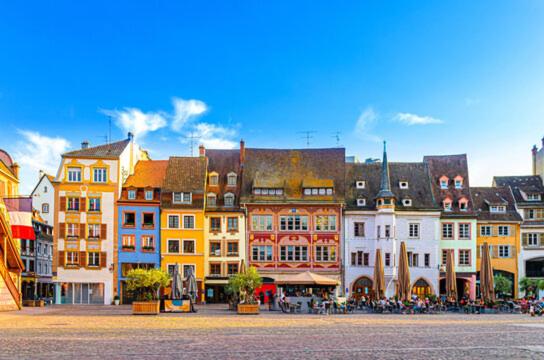 a group of colorful buildings in a city at Au Petit Colombage - Cosy au centre de Mulhouse - Gare proche in Mulhouse