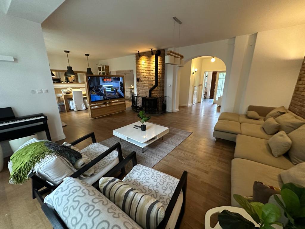 a living room with a couch and a piano at Dako Apartment, Luxurious, Cosy, Spacious in Rzeszów