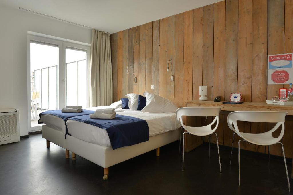 Postel nebo postele na pokoji v ubytování Hotel Aan Zee