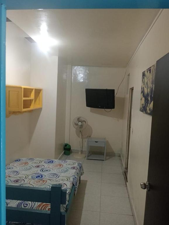 a room with a bed and a flat screen tv at Hotel Danubio Azul in Yopal