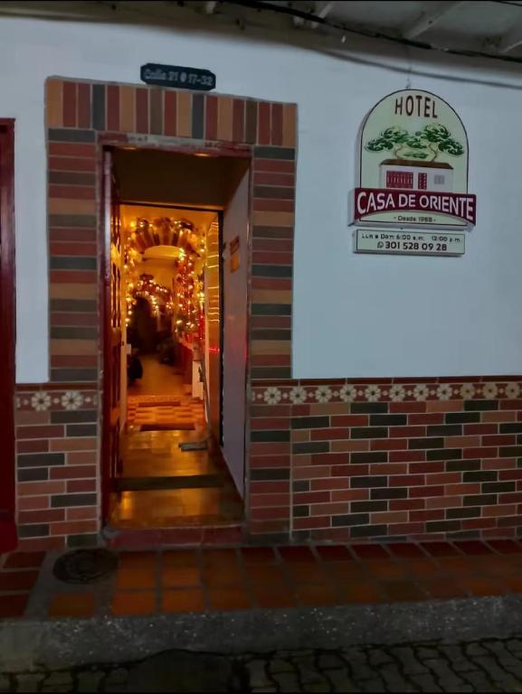a building with a sign that reads hotel csa be orange at Hotel Casa de Oriente in San Bartolo