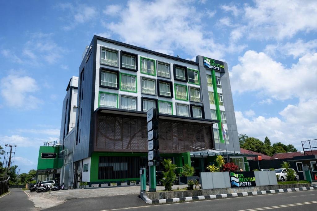 a large building with green and gray at DK Belstar Hotel Belitung in Tanjungpandan