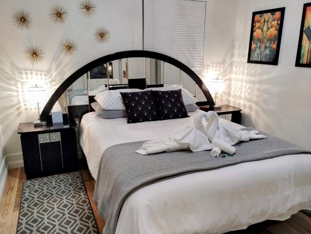a bedroom with a large bed with towels on it at Deco Studio Retreat with Fireplace, WiFi, Queen Bed in Reno