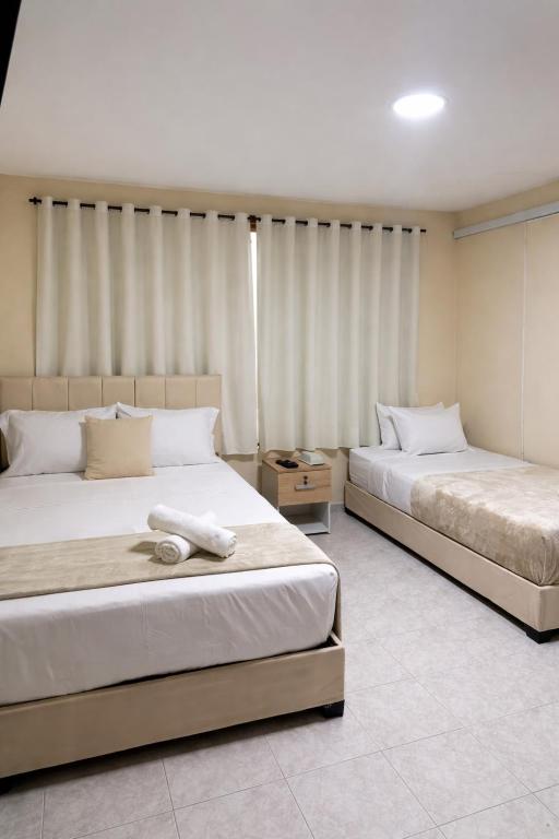 two beds in a hotel room with two bedsvisor at Hotel ladymar cartagena in Cartagena de Indias