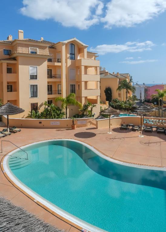 a large swimming pool in front of a building at Terrace View - Estrela Apartment in Luz