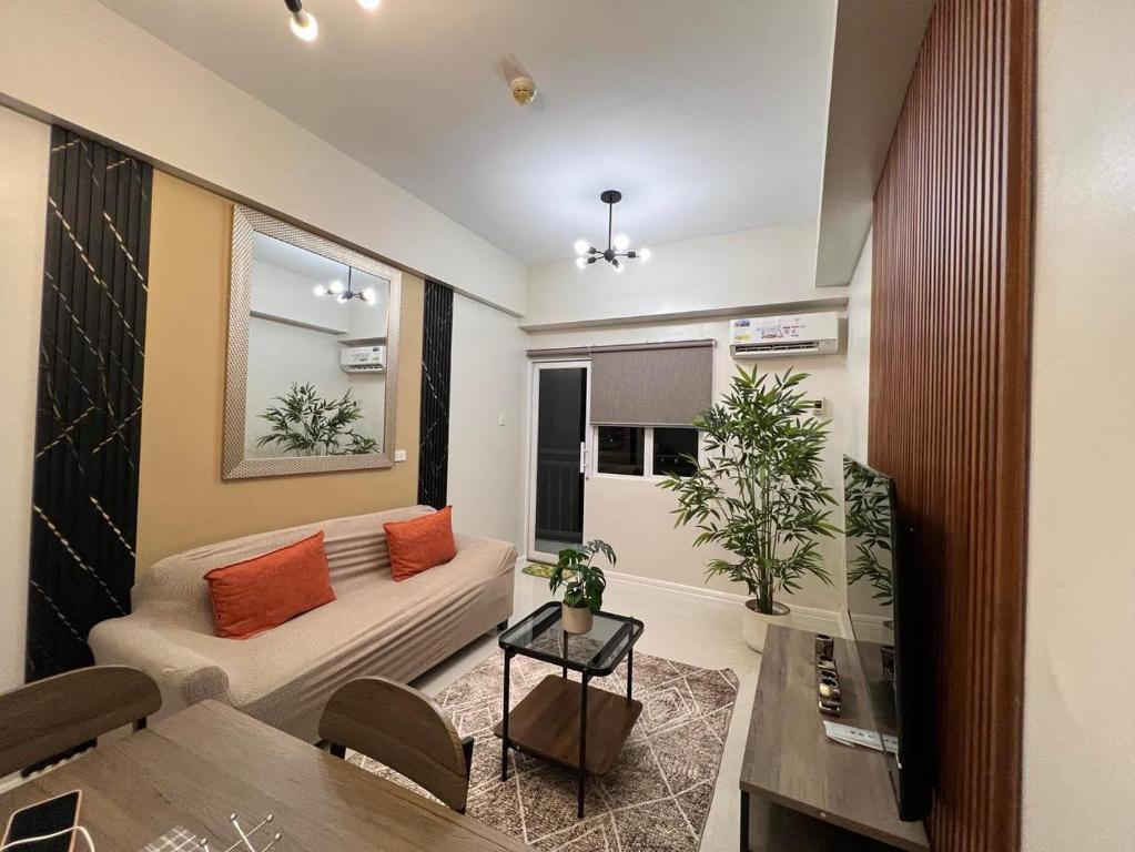 a living room with a couch and a table at KEY REALTY SERVICES Ph in Lapu Lapu City
