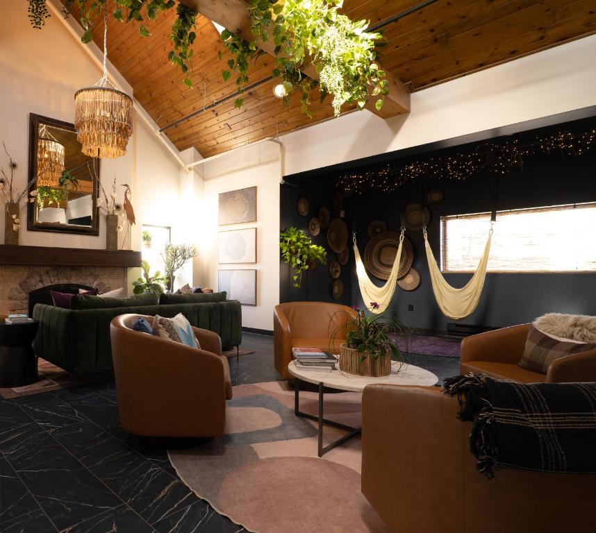 a lobby with couches and chairs and a table at Violet Inn, Lounge & Spa in Two Rivers