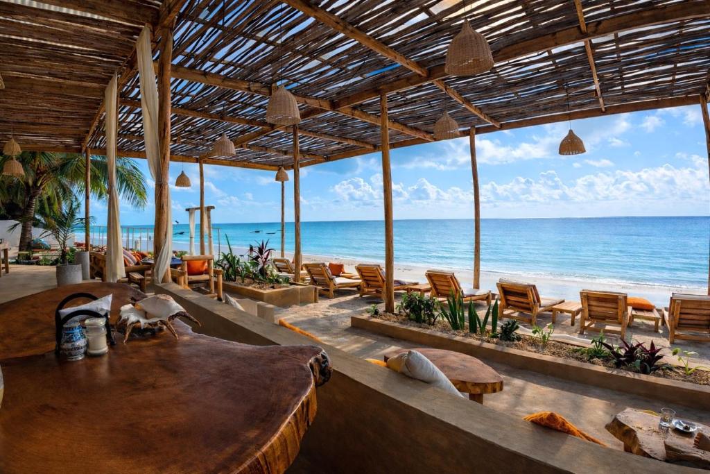 a restaurant on the beach with a view of the ocean at HA Beach Breeze in Jambiani