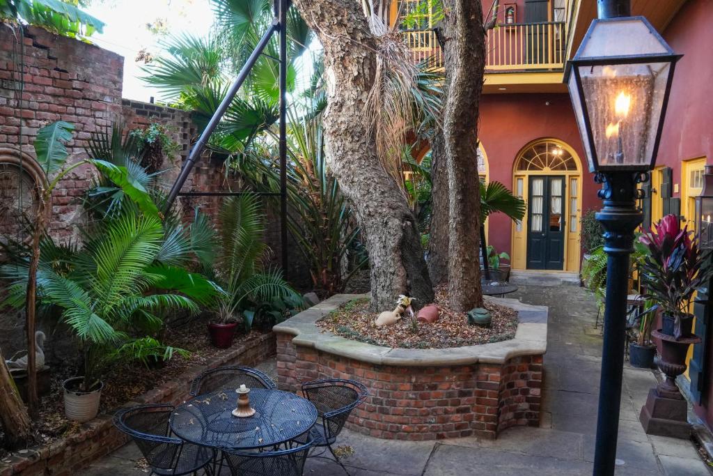 a courtyard with a tree and tables and a street light at The Olivier House Hotel in New Orleans