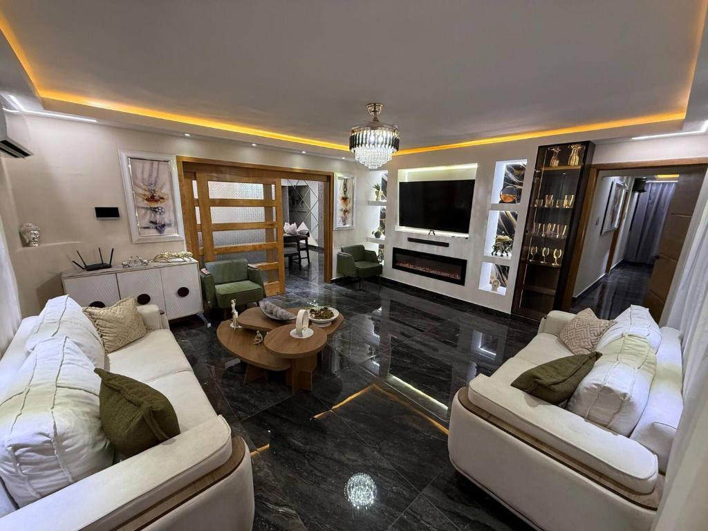 a living room with two white couches and a tv at propiedad para pasarla bien in La Grúa
