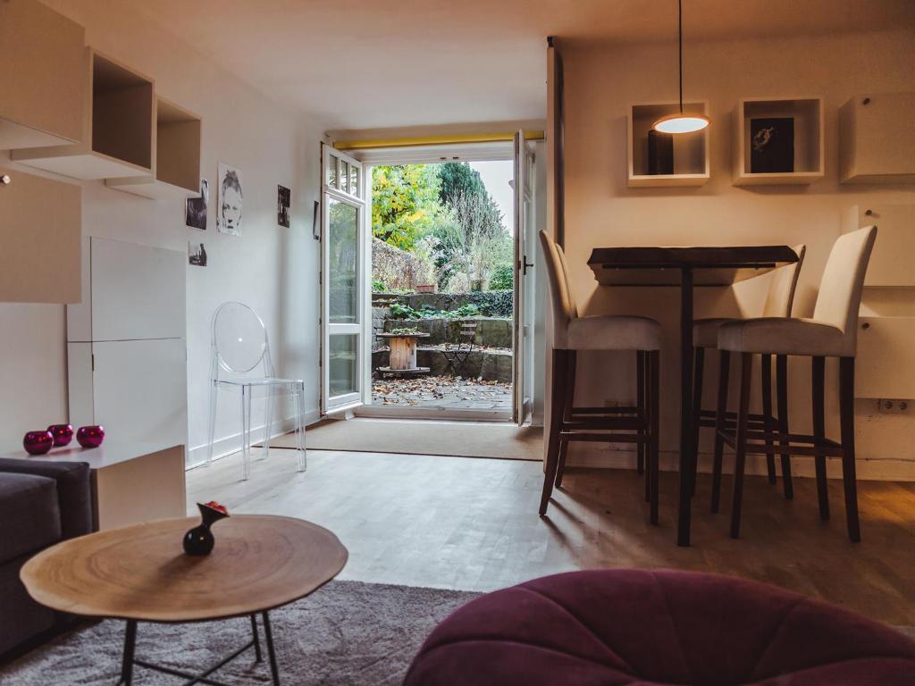 a living room with a table and a kitchen with a window at Kassel in Kassel