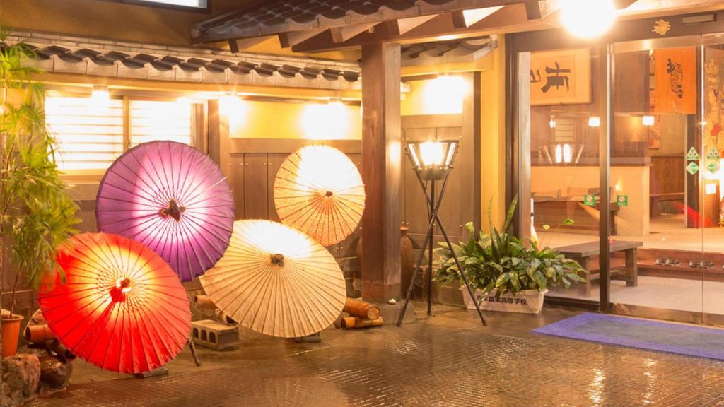 a group of umbrellas on display in a room at Yamaga Onsen Sumi in Yamaga