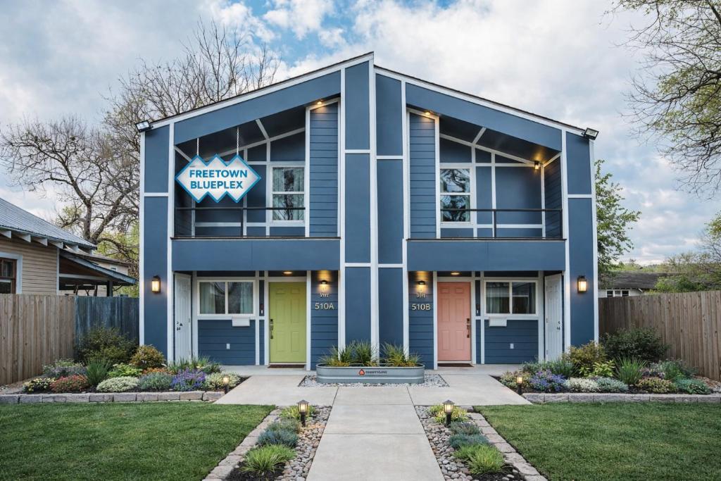 a blue house with a sign that reads attentionagencyagency at Freetown Blueplex Downtown Lafayette in Lafayette