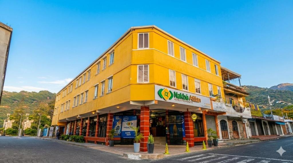 a yellow building on the side of a street at Hotel Nakbé Atitlán in Panajachel