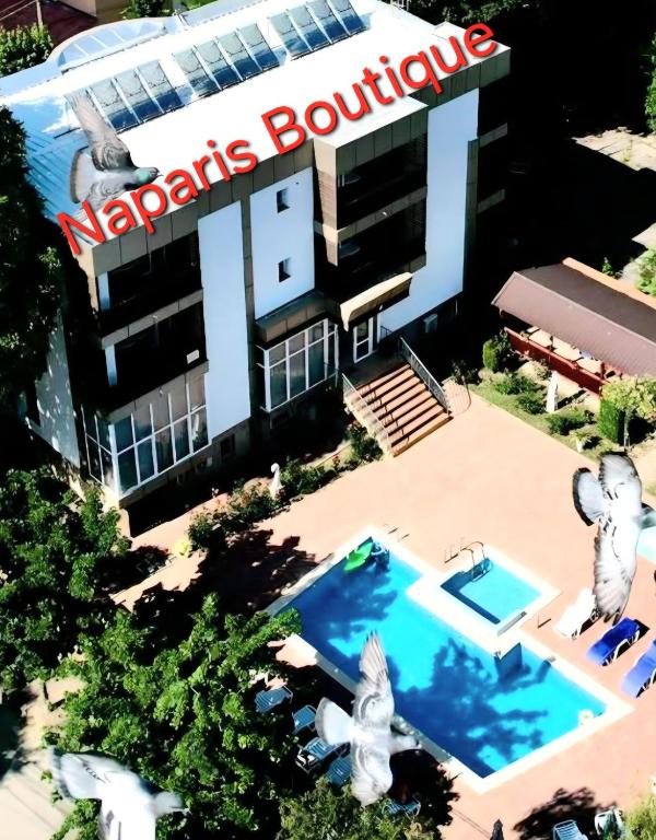 an aerial view of a building with a swimming pool at Naparis Boutique in Eforie Sud