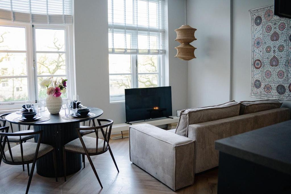 a living room with a couch and a table at Naest - Authentic Escapes Old Town Villa Nijmegen in Nijmegen