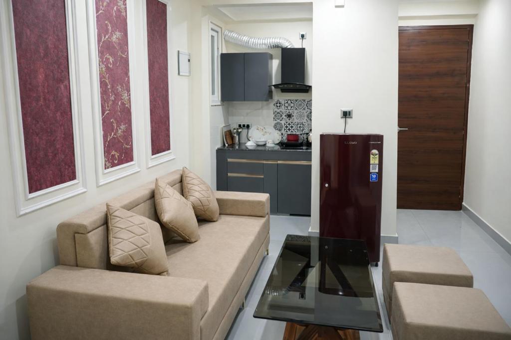 a living room with a couch and a table at Rudra Homestay - Rishikesh in Rishīkesh