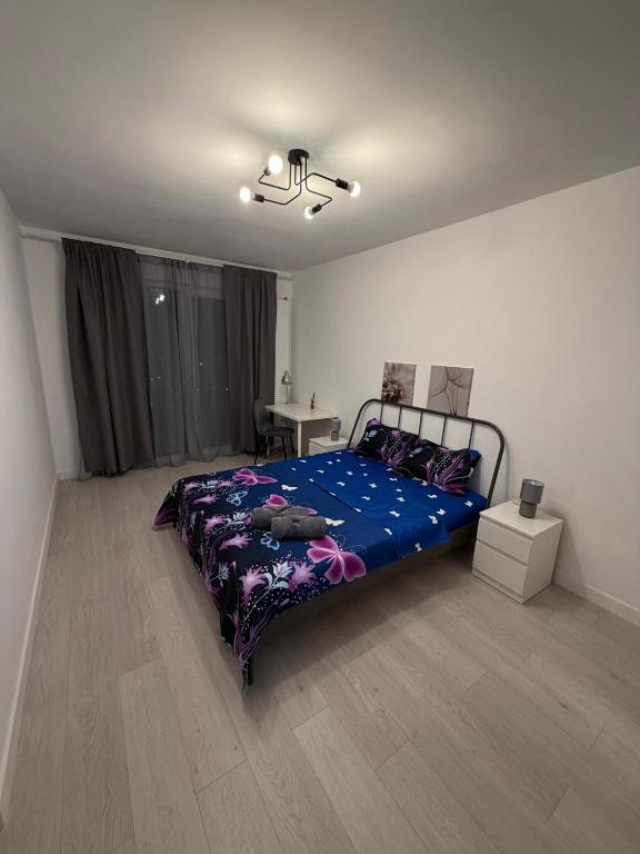 a bedroom with a bed and a table in it at White House in Ploieşti