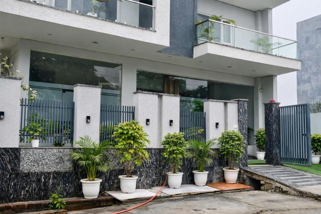 a house with plants in front of it at Hotel Stayzzy Bloom in Noida
