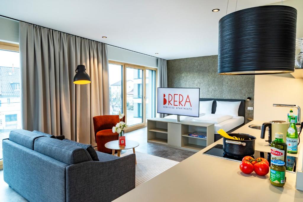 a living room with a couch and a bed at Brera Meckenbeuren-Friedrichshafen in Meckenbeuren