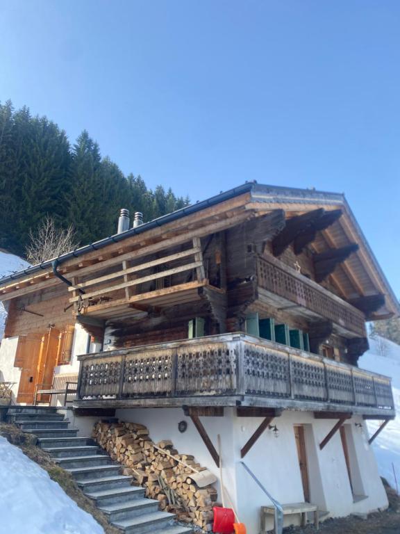 a log cabin with stairs and a balcony at Boutique Chalet Panoramic Views Hot Tub in Vers L'Eglise