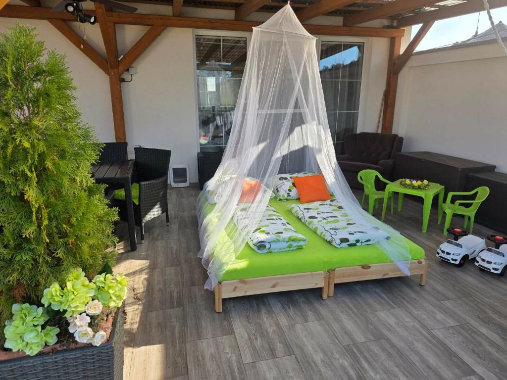 a bed with a mosquito net in a living room at Pohádka- v srdci Pálavy a Lednice in Rakvice