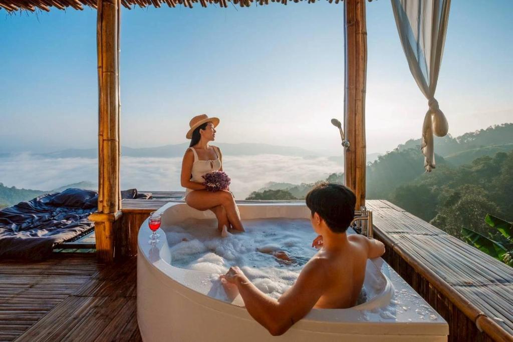 a woman and a boy sitting in a bath tub at Mon Ngo misty haven B1 in Ban Mae Ta Man