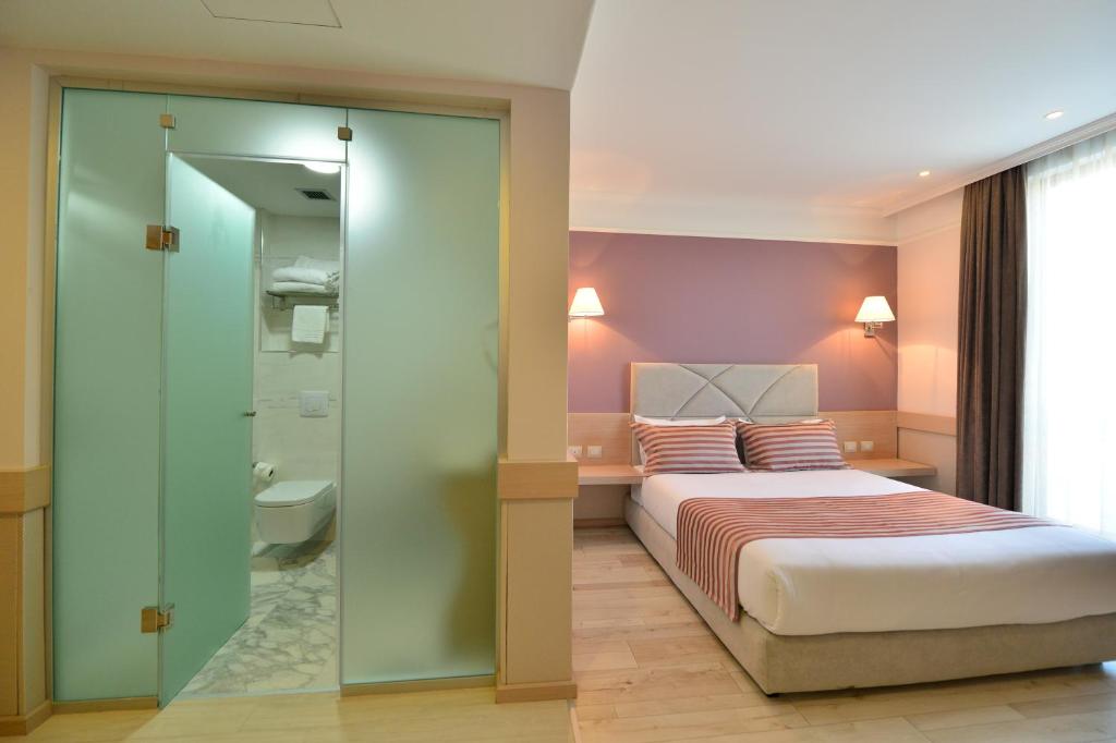Postel nebo postele na pokoji v ubytování Te Stela Resort & SPA