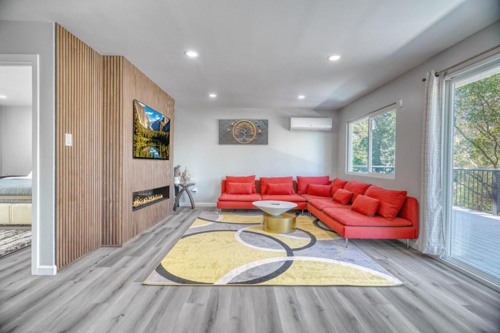 a living room with a red couch and a rug at Modern Luxury Sierra Lodge | 3BR, 3BA | Hotel Vibe in Groveland