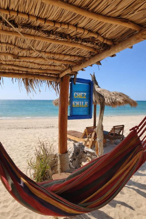 a hammock on a beach next to the ocean at Chez Émile in Anakao