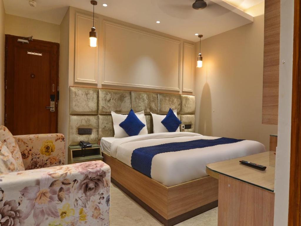 a hotel room with a bed and a chair at Hotel Maya Cottage' Newly Rebuilt 2026' Near New Delhi Railway Station & Connaught place in New Delhi