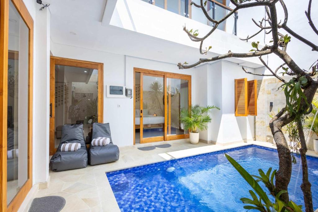 a villa with a swimming pool in a house at Villa Surga in Denpasar