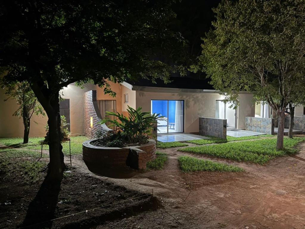 a house with a blue door in a yard at Redem House in Modimolle