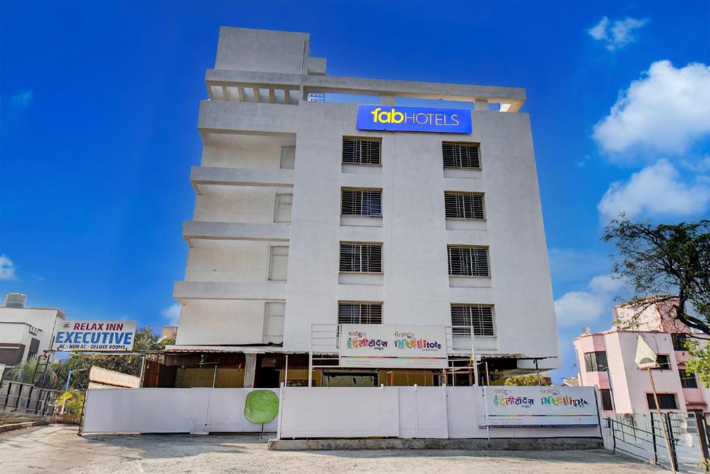 a building with a units sign on it at FabHotel Relax Inn Executive in Pune