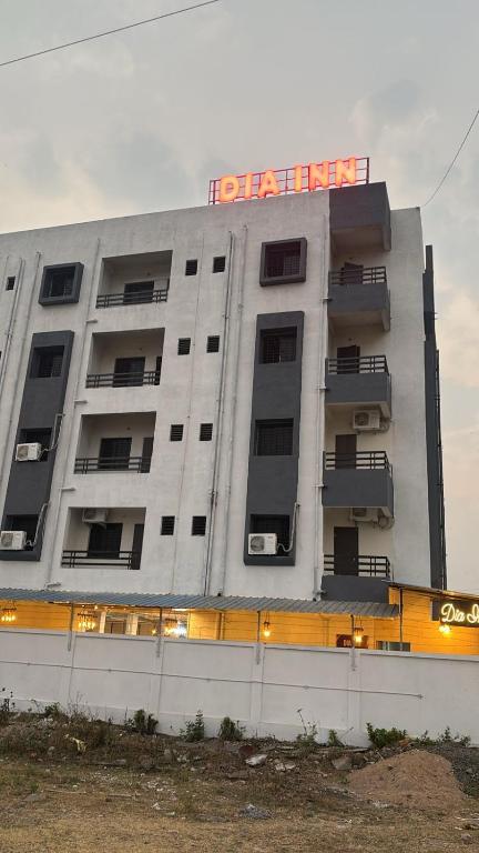 an apartment building with a hotel sign on it at Dia Inn in Bori