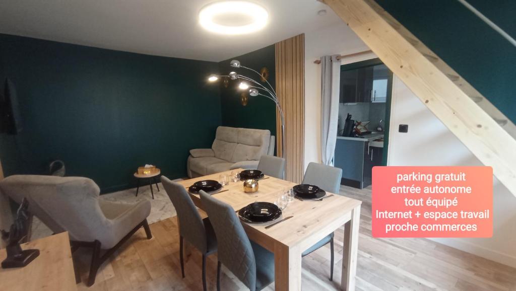 a dining room with a table and chairs in a room at Au 24 a connerre in Connerré